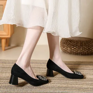 Elegant black square toe pumps with a sparkling rhinestone buckle and thick block heel.