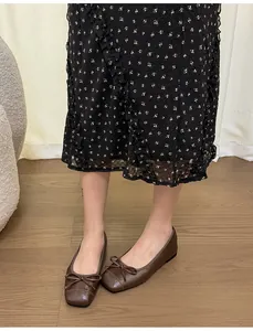Detailed view of elegant brown French style ballet flats with bow detail and square toe