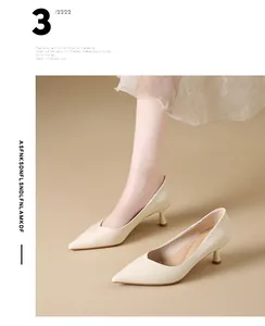 Detailed view of elegant cream pointed-toe kitten heel pumps on model