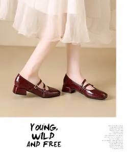 Close-up detail of burgundy patent leather Mary Jane shoes with square toe