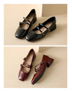 Detail view of ballet-style square-toe Mary Jane shoes in black and burgundy leather.