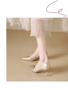 Close-up of elegant champagne gold pointed-toe kitten heels for women's commute