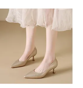 Close-up of elegant champagne gold pointed-toe pumps with kitten heels