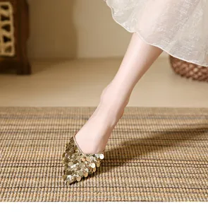 Elegant golden sequin pointed-toe mules for women shown in a detailed close-up shot