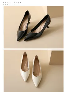 Detailed view of elegant pointed toe stiletto pumps in black and cream soft leather