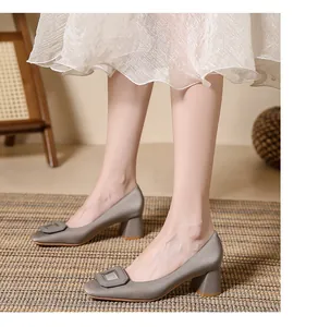 Elegant silver satin block heel pumps featuring a square toe and decorative buckle detail