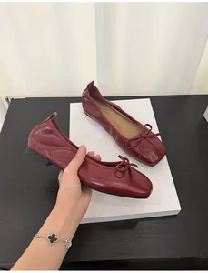 Burgundy square toe ballet flats with bow detail and glossy finish detail shot
