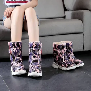 Close-up of pink camouflage kids snow boots with warm fur lining and thick non-slip soles
