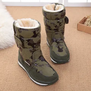 Detailed macro view of children's camo snow boots featuring thick white faux fur lining.