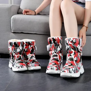 Detailed view of children's camouflage snow boots with thick fur lining and anti-slip sole