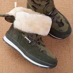 Close-up of children's army green camouflage snow boots with thick faux fur lining