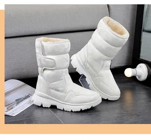 Detailed view of white camouflage snow boots with plush lining and non-slip sole