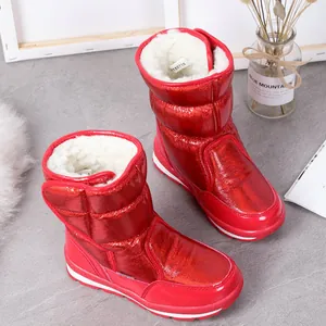 Close-up of vibrant red metallic snow boots with plush faux fur lining for kids
