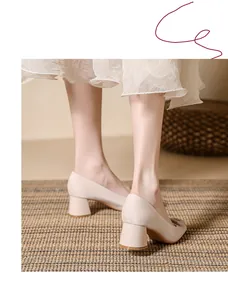 Elegant beige satin chunky heel pumps shown from a stylish back view on a model