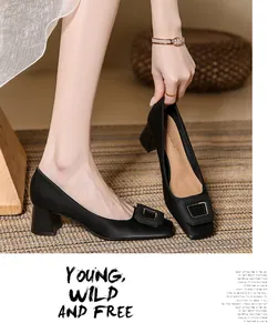 Detail of black satin chunky heel pumps with elegant square toe and buckle