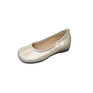 Elegant champagne split-toe tabi ballet flats featuring soft metallic leather finish
