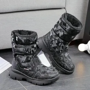 Close-up of children's camouflage snow boots with thick faux fur lining and non-slip soles.