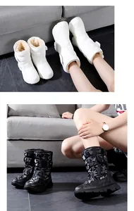 Detailed view of white and camouflage waterproof snow boots with warm faux fur lining