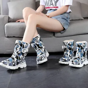 Close-up of children's blue camouflage waterproof snow boots with a thick non-slip white sole