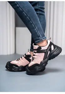Detailed side view of stylish pink and black steel toe safety shoes worn by a model