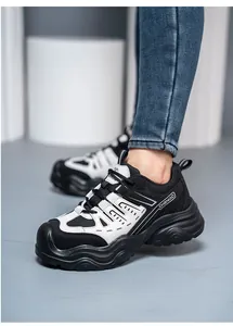 Detailed view of stylish black and white breathable women's steel toe safety work shoes