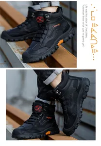 Black safety work boots with 6KV insulation and orange accents on steel beams.