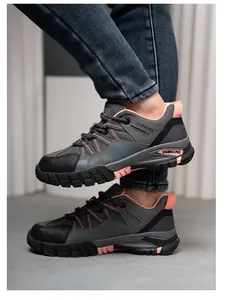 Detailed side view of grey women's breathable safety shoes with pink accents and rugged sole