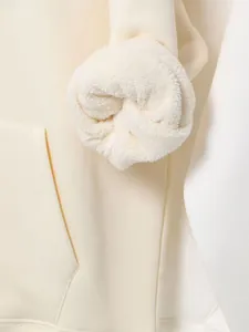 Detailed view of cream heavy hoodie sleeve showing soft white fleece lining texture