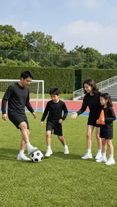 Family wearing black long-sleeve athletic sets playing soccer together on grass pitch