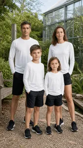 Family matching set of white long sleeve athletic tops and black shorts outdoors