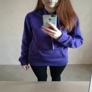 Casual purple unisex pullover hoodie with hood and kangaroo pocket mirror selfie view