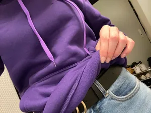 Close-up detail of a purple hoodie showing soft warm fleece lining texture