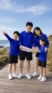 Detail showing a family in blue athletic shirts looking at a map on a sunny outdoor boardwalk