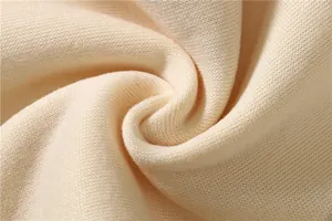 Macro view of cream soft cotton fleece fabric texture for hoodies