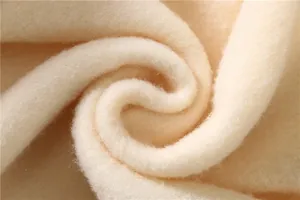 Macro detail shot showing the soft and warm beige fleece lining of a winter hoodie