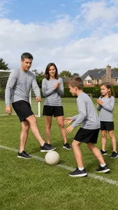 Family playing soccer outdoors wearing grey long-sleeved sports training activewear