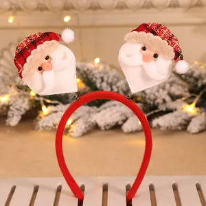 Close-up of festive Christmas headband with springy Santa Claus plush decorations