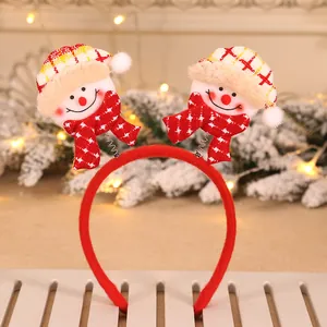 Close-up of festive Christmas headband with two plush snowman characters on springs