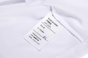 Detail view of garment care label showing 100% polyester fabric and size M