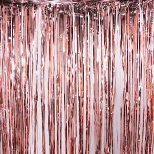 Shimmering rose gold foil fringe curtain for festive party background wall decorations.