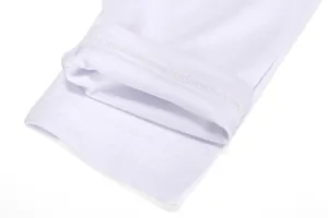 Close-up detail of white long-sleeved sports shirt cuff showing high-quality stitching and fabric