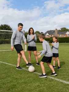 Family matching gray long sleeve sports shirts and black shorts on soccer field