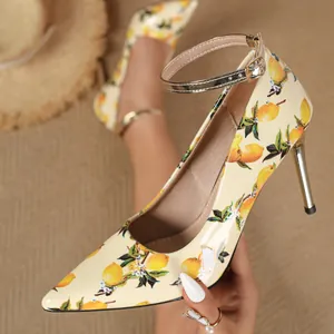 Close-up of elegant lemon print high heels with pointed toe and ankle strap.