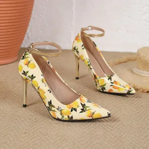 Close-up of lemon print detail on pointed toe stiletto heels with gold ankle straps.