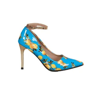 Elegant light blue pointed-toe pumps with vibrant lemon print and gold ankle strap.