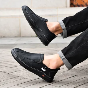 Detail view of black leather men's casual shoes featuring unique hand-stitched seams
