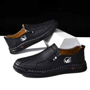 Detailed view of black hand-stitched men's casual leather shoes with metal zipper