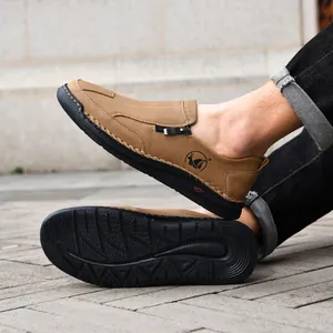 Detail view of brown men's casual leather shoes with handmade stitching and anti-slip sole.