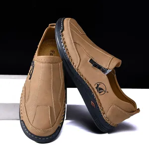 Detail view of tan men's casual leather loafers with hand-stitched seams and zipper