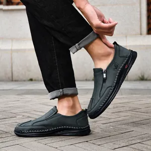 Detailed side view of dark green men's leather casual shoes featuring hand-stitched seams